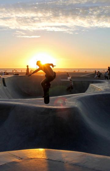 Silhouette skateboard man